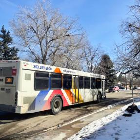 a bus driving on Moorhead Avenue