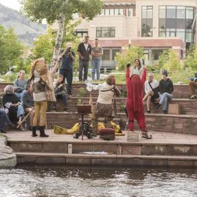 Performers on stage by the Boulder Creek.