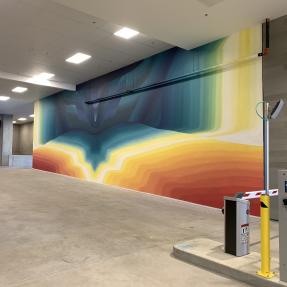 A mural of colors coming together in the middle to create an abstract wall