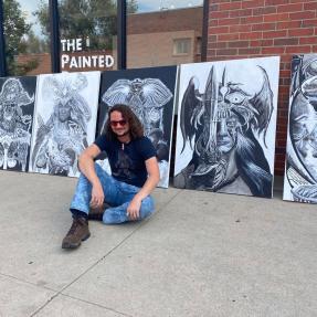 artist in front of black and white characters 