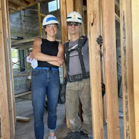 Hollie and Kurt in a mid-construction Habitat for Humanity home.