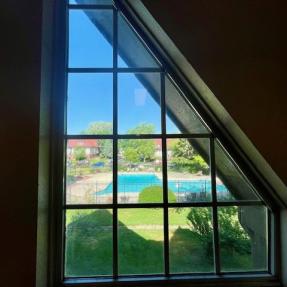 view of community pool from common hallway