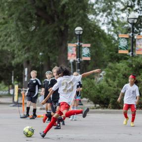 Kids playing soccer on 13th Street