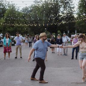 Community members dancing in the middle of 13th Street