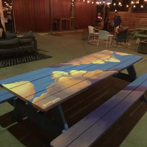 Picnic table with clouds and the sky covering it