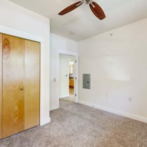 Other view of bedroom with fan and large closet 