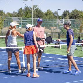 Community members playing on a racket sport court