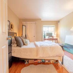 Bedroom view from door and  tall standing lamp 