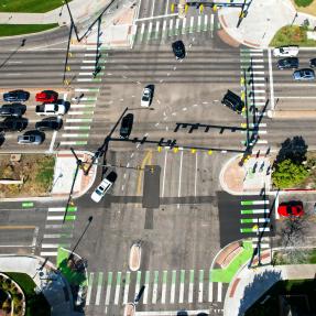 28th and Colorado intersection from above. Buses, cars, bikes and people walking travel. 
