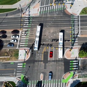 28th and Colorado intersection from above. Buses, cars, bikes and people walking travel. 