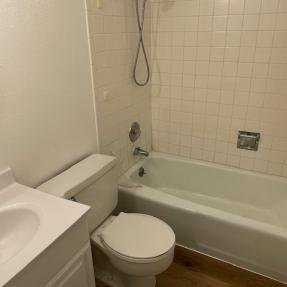3150 Iris Ave #F211 - shared full bathroom with bathtub new flooring in hallway