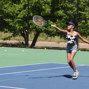 Kid playing tennis at the East Boulder Community Park tennis courts