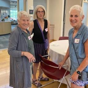 Three women gather to chat at the Ice Cream Social