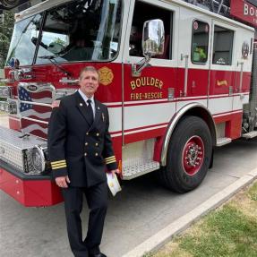 chief lowrey, boulder fire marshal standing in front of boulder fire rescue engine