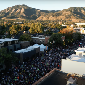 Aerial view of downtown Boulder with runners lined up for a race