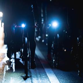 Darkness with two bikes barely visible with their headlights on