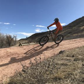 Mountain biker riding down a curved trail section