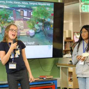 Two students give a presentation about The Nest.