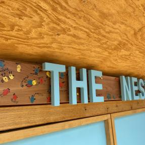A close-up view of The Nest sign.