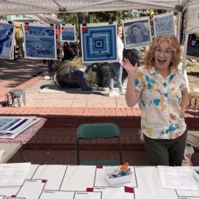Woman standing behind table with fabric