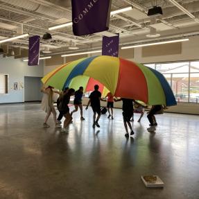 Amico campers playing a parachute game