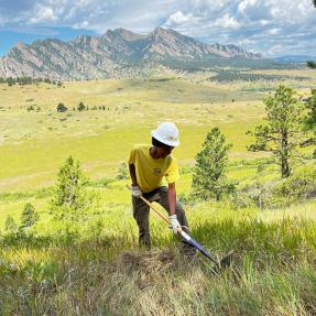 Junior Ranger starts the cut of a new trail