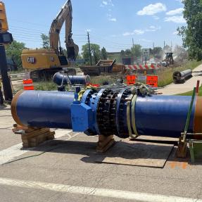 63rd Street waterline valve assembly; large blue pipe aboveground near construction