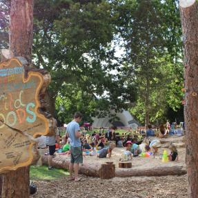 Wild Woods nature play area sign and sand pit with children