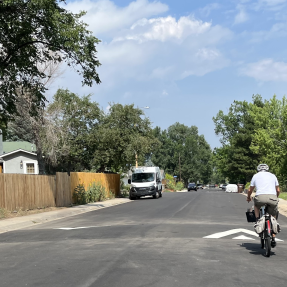 A bicyclist riding over a speed hump on Martin Drive