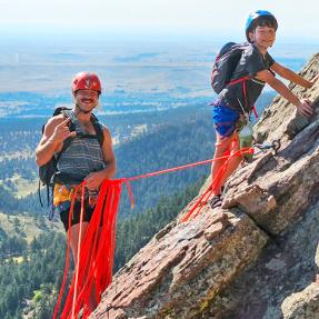 David Hebel and his son on the slanted 3rd Flatiron with Boulder far below.