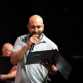 Motus Theater employee on stage during the Elevate Boulder monologue performance at Motus Theater.