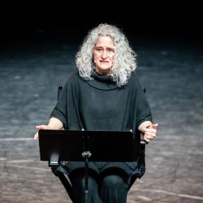 Elevate Boulder participant on stage during their monologue performance at Motus Theater.