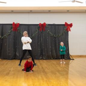 2 kids 1 adult dancing on stage
