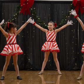 Dancers in white and red stripes performing in Winter Dance Concert 2024
