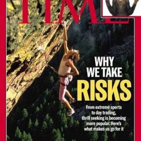 TIME Magazine cover titled Why We Take Risks showing a climber hanging off a rock formation.