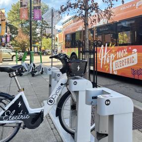 BCycle, lime e-scooters and HOP bus traveling downtown