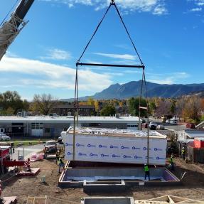 First section of modular home being placed on the foundation. 