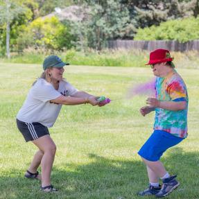 Campers gets sprayed with color powder during color run obstacle course