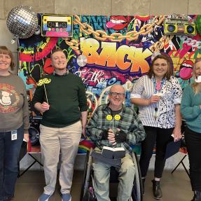 City staff at a photobooth at an employee event
