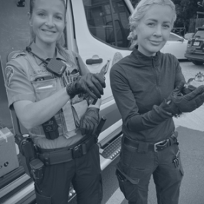 BPD Officers smile for a photo outside of the animal control vehicle