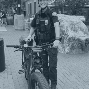 BPD Officer and her bike pose for a picture while on the Pearl St Mall