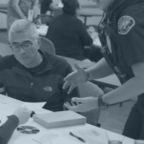 BPD Officer helps a community member with a task