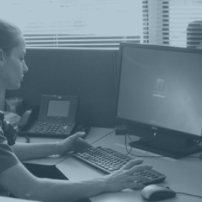 Boulder police officer working at a computer
