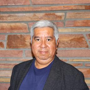 Person standing with a brick wall background