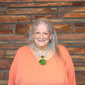 Person with a brick wall background