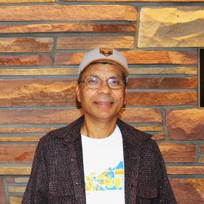 Person standing with a brick wall background