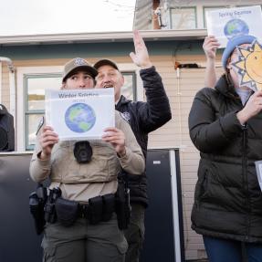 Rangers holding pictures of the earth from different angles