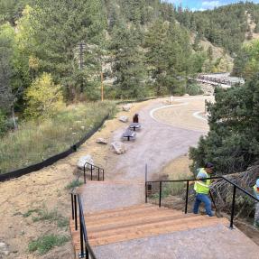 Stairs at a trailhead surrounded by trees