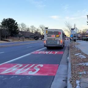 The regional RTD JUMP bus on a newly painted bus and turn lane. 