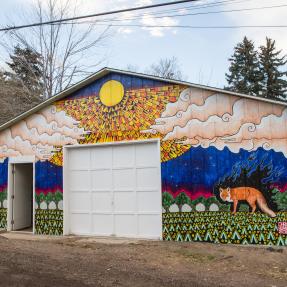 Mural of a fox on the side of a garage